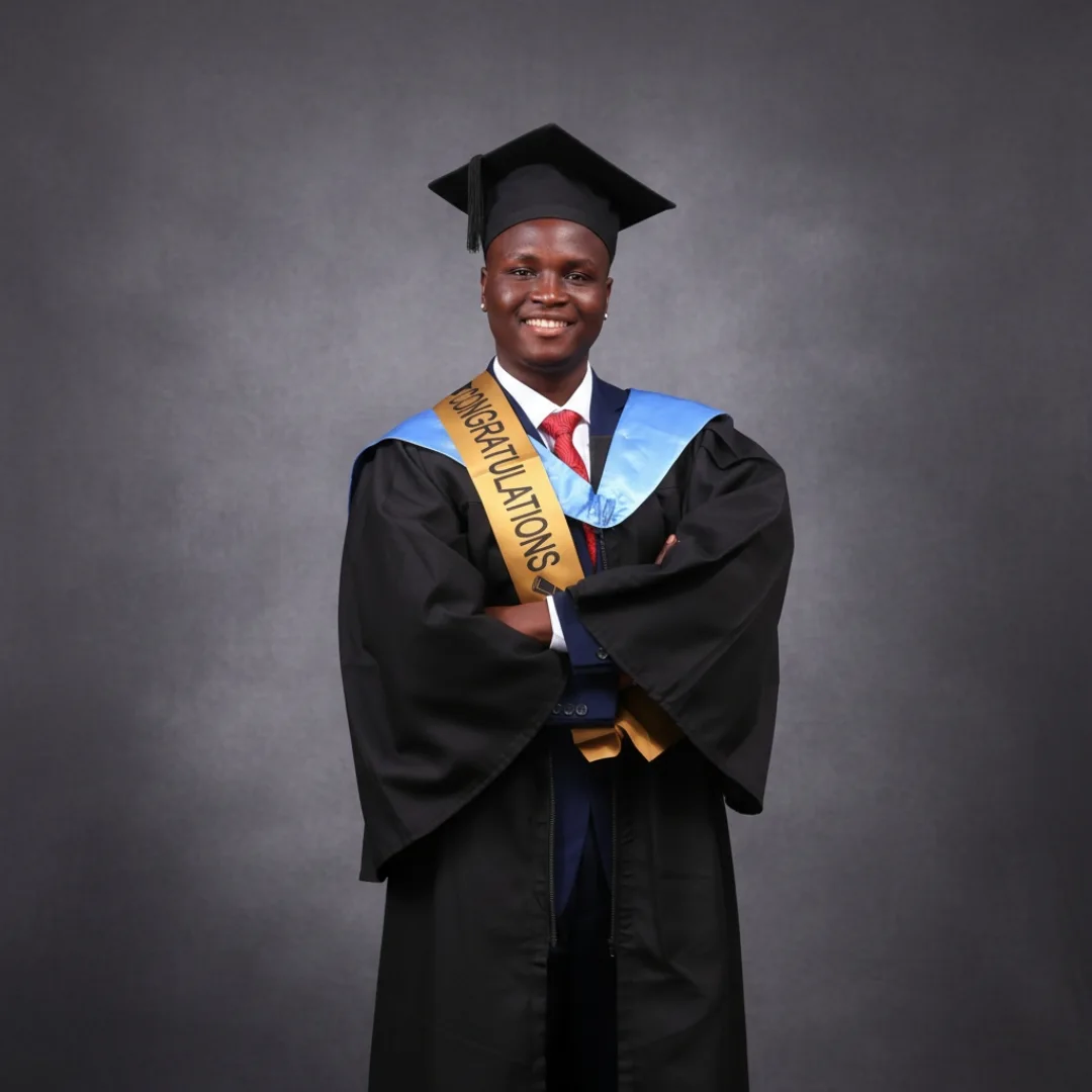 Eugine Micah in graduation gown and sash