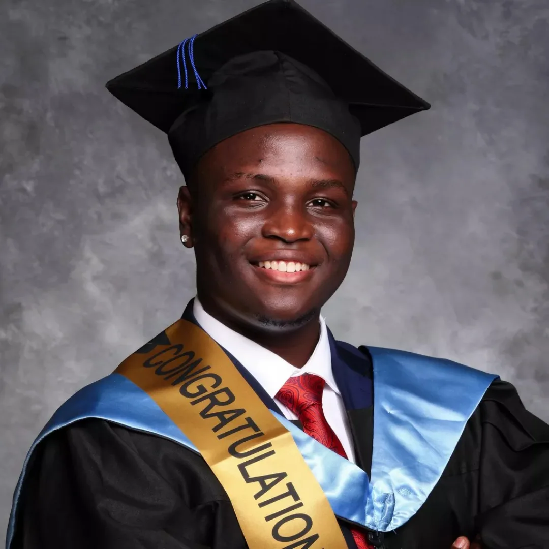Eugine Micah in graduation gown